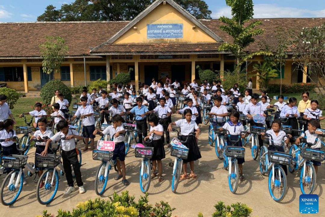 Instituições de caridade chinesas doam bicicletas e mochilas para estudantes do Camboja